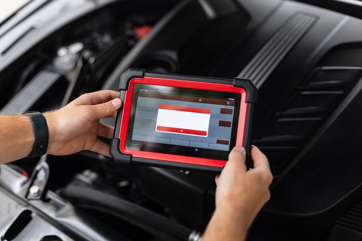 Technician performing vehicle inspection